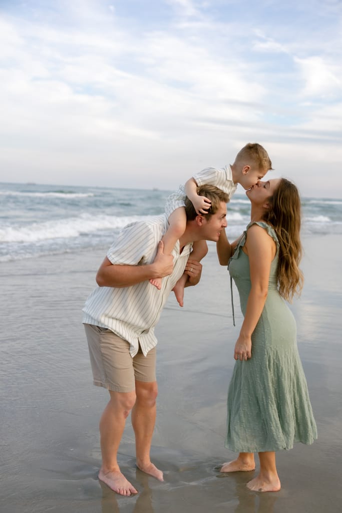 Family portraits on Atlantic Beach with parents and child. 