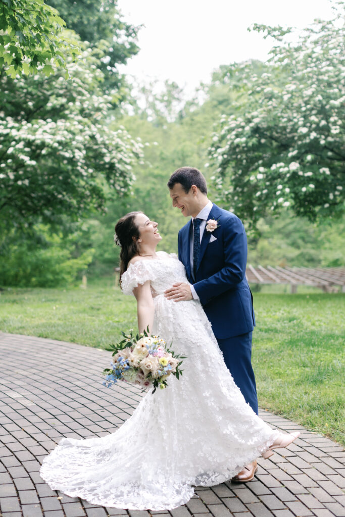 A bride and groom laugh and dip before their luxury wedding in France