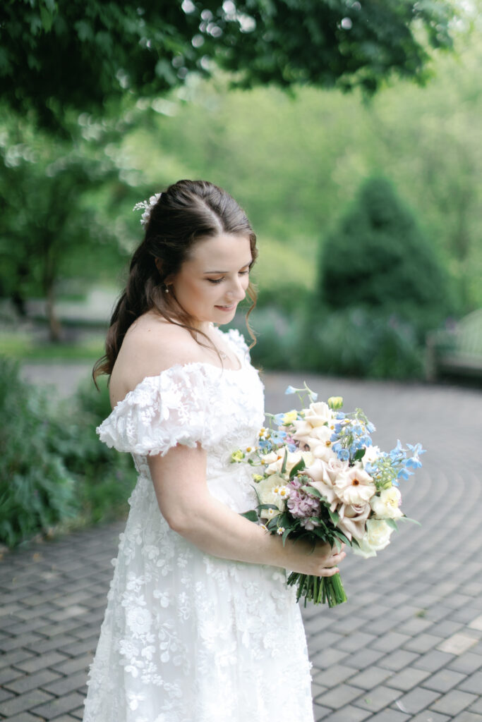 A bride holds her lavish wedding bouquet during bridal portraits in Chateau France