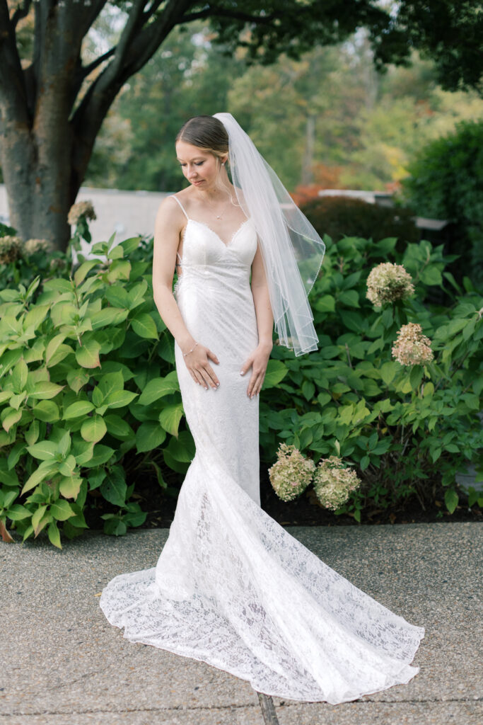 A bride stands for bridal portraits in a lace dress by Anthropologie BHLDN