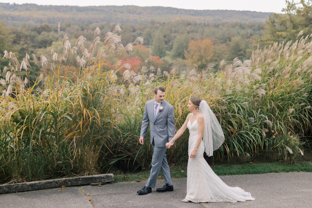 A bride and groom walk hand in hand in Beaufort North Carolina