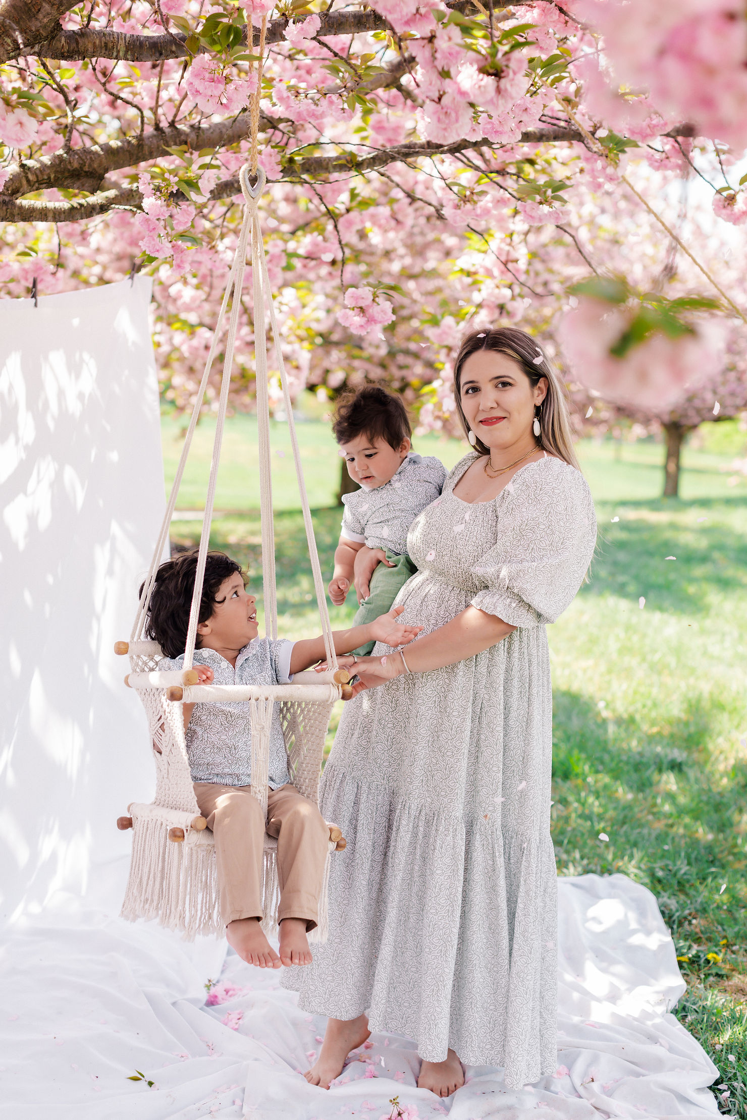 Mother and child laughing together at a styled photography session with white and pink roses in Beaufort, North Carolina.