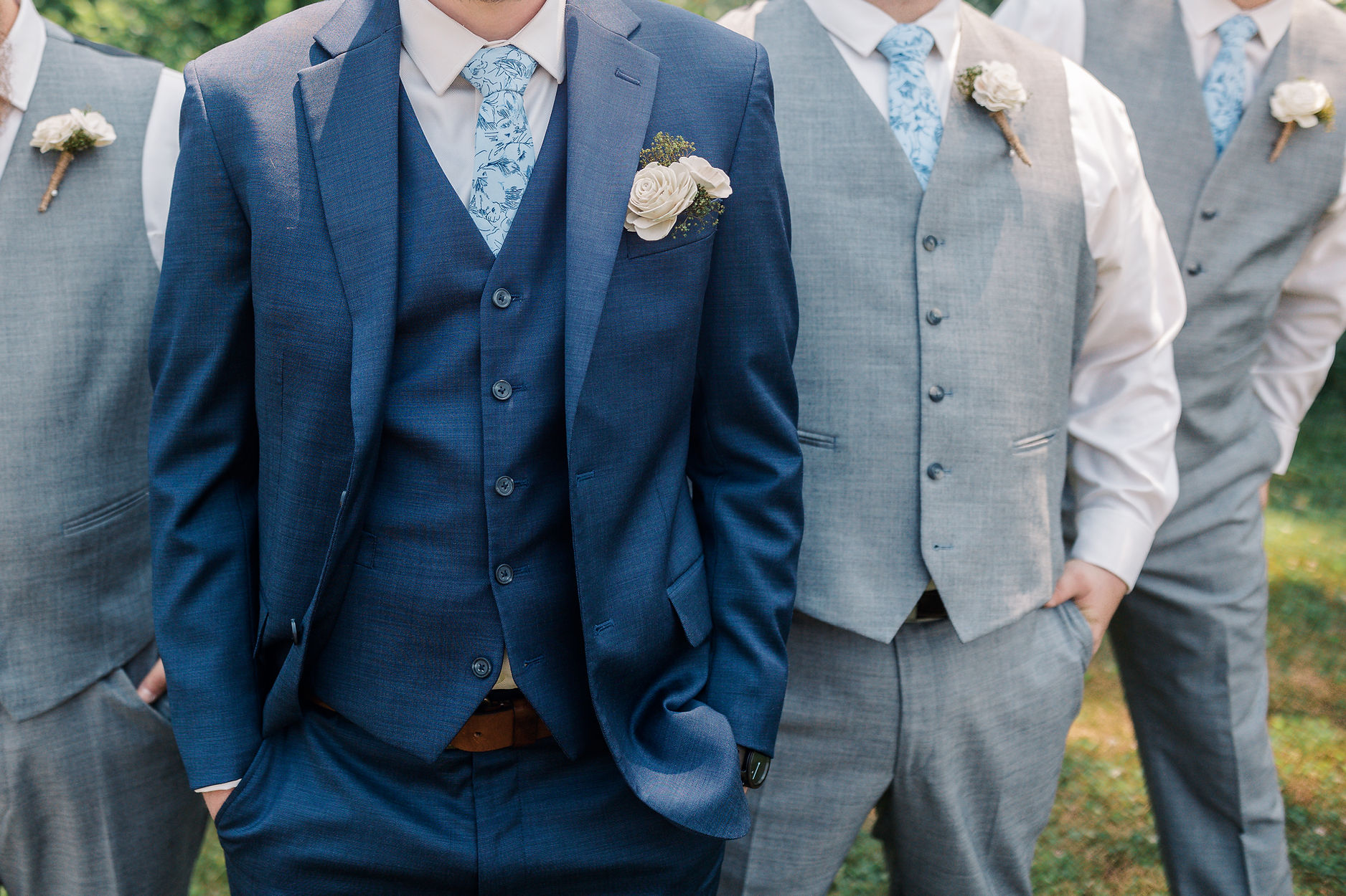 groomsmen blue and grey attire with patterned ties