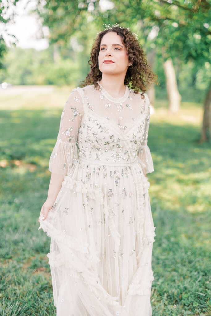 A bride wears a simple wedding dress with statement sleeves and ornate beading