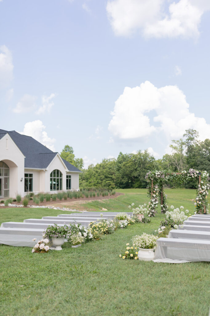 Outdoor ceremony arbor with ivory and green florals at Donovan Manor North Carolina