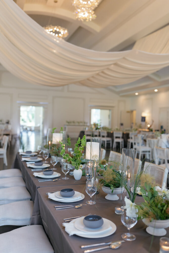 A floral and sculptural installation surround this indoor ceremony at a Donovan Manor wedding