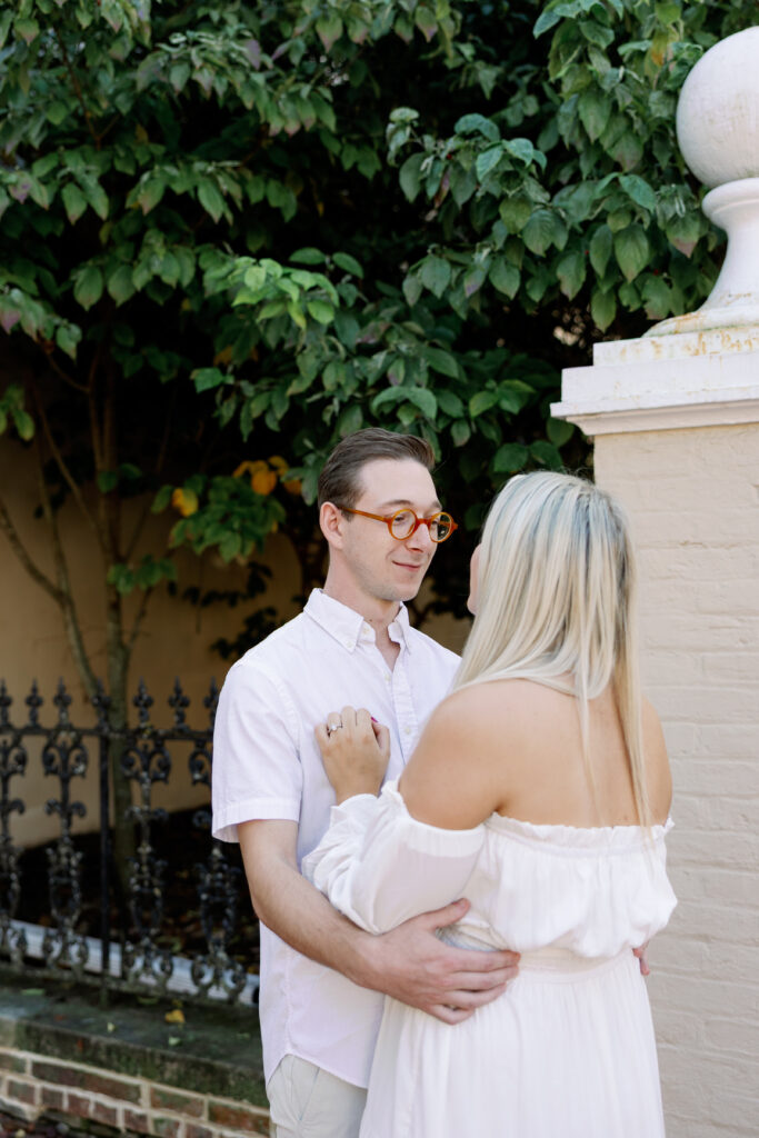 Romantic pose at iron gate near Baker Park during engagement session