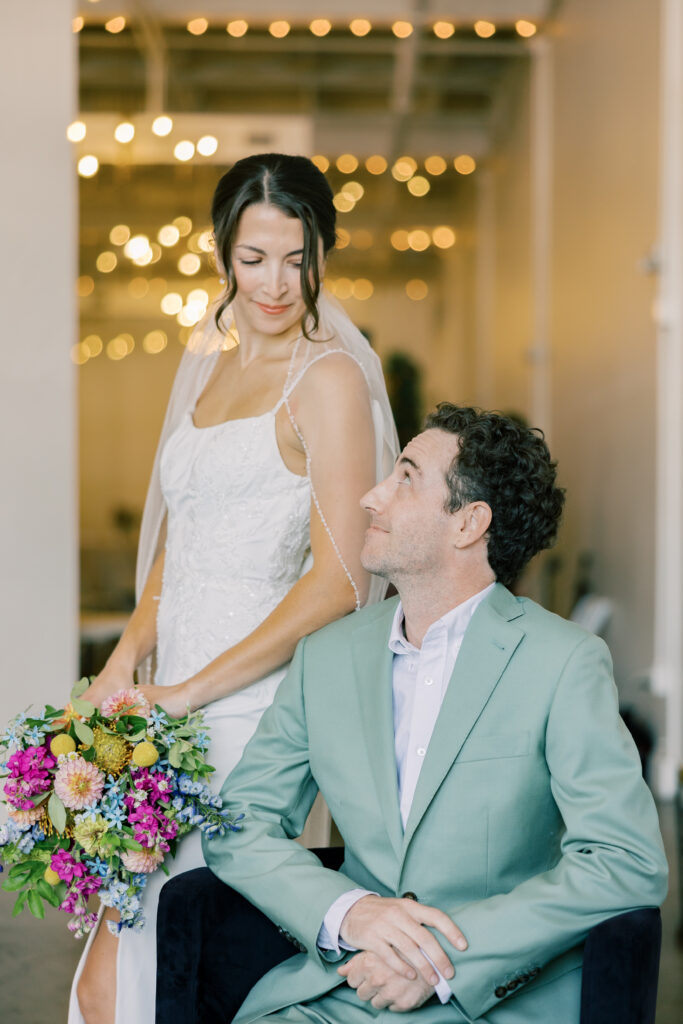 A bride and groom during their wedding portraitures the groom is wearing a pop of color in Paloma palettes