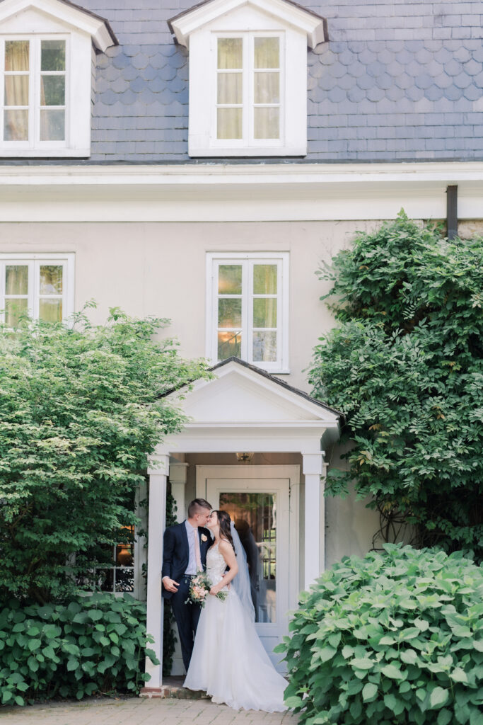 A bride and groom pose for wedding photos at a chateau in France 