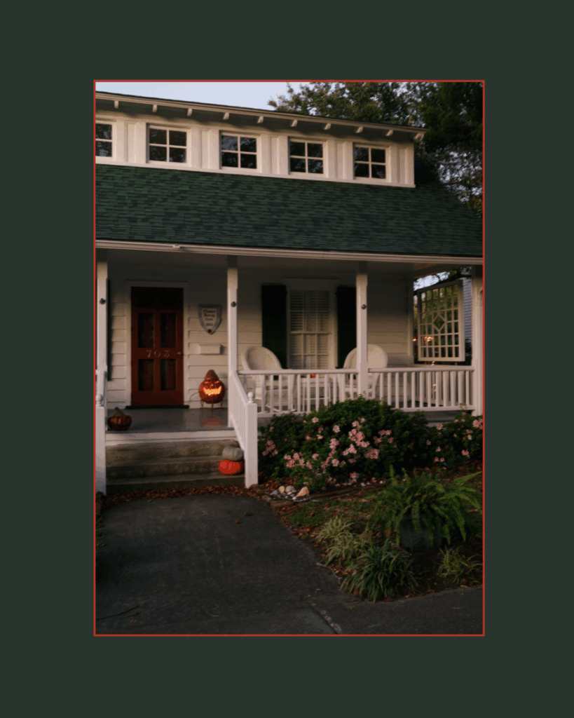 Cozy Beaufort NC home decorated for Halloween with a glowing jack-o-lantern on the porch, captured in golden evening light by Beaufort NC lifestyle photographer.