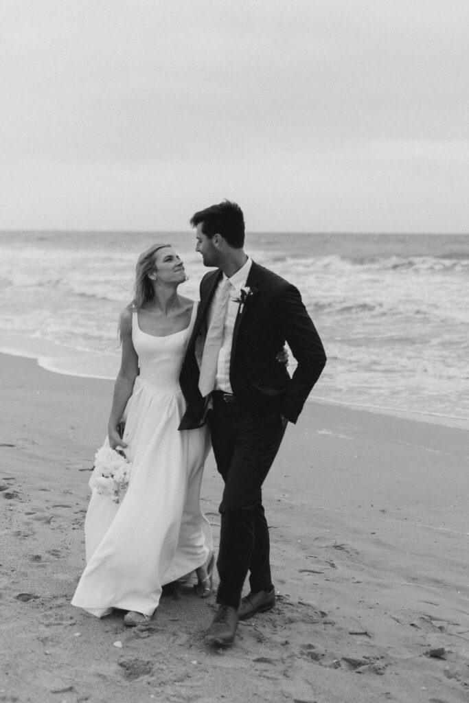 Bride and groom portraits on the sand outside The Dunes Club in Atlantic Beach, NC, black and white.