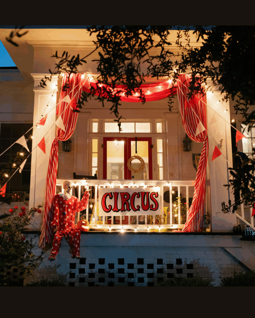 Festive circus-themed Beaufort NC porch with red and white drapes, glowing lights, and a hand-painted circus sign — photographed by Beaufort NC Hailey Rae photographer.