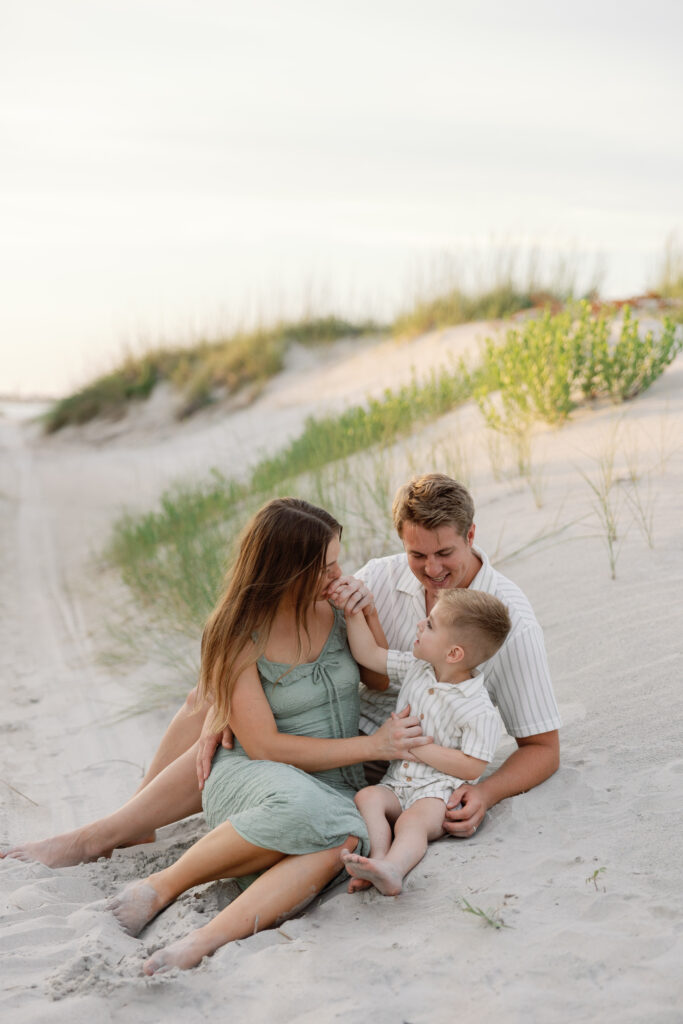 A family plays in the sand at Fort Macon State Park. 