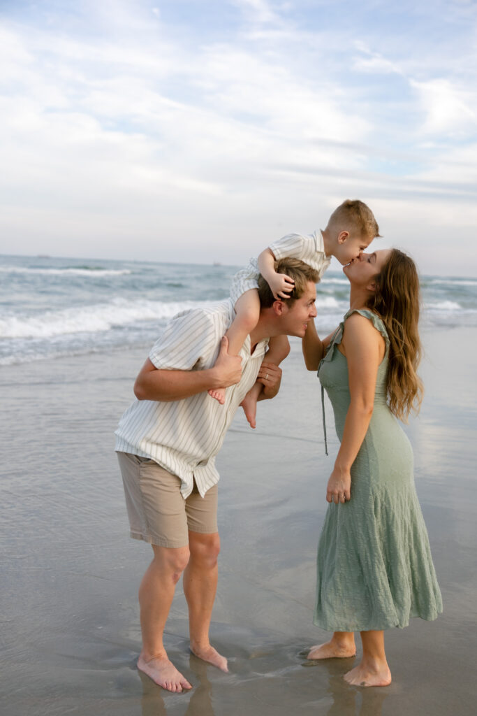 Family portraits on Atlantic Beach with parents and child. 