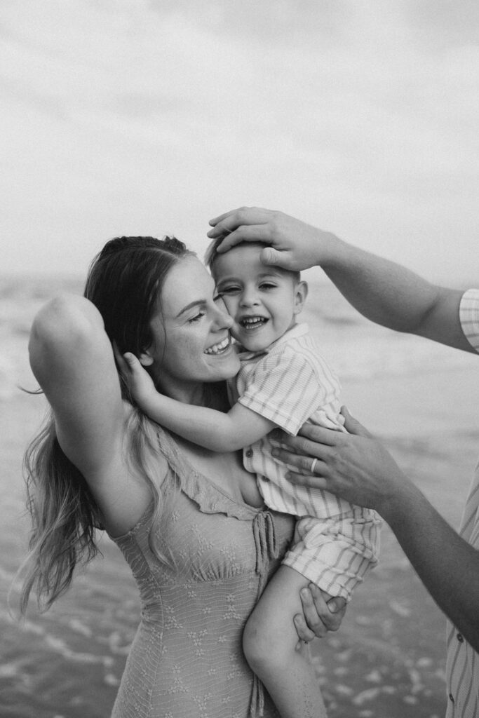A mom holding her son close on Atlantic Beach