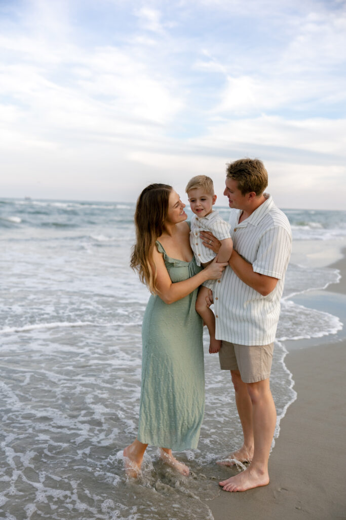 Natural family photography session on Atlantic Beach featuring candid moments and warm coastal light.