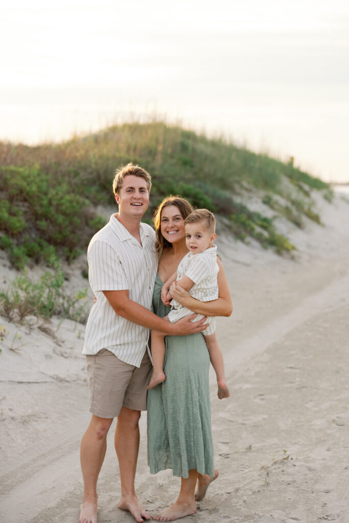 Crystal Coast family portraits with sea oats and rolling sand dunes at sunset.