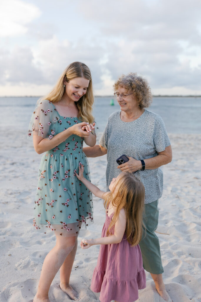 Family portraits capturing the emotions after a surprise beach proposal