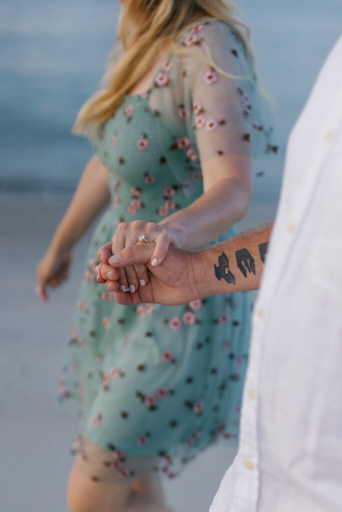 Couple walking along Fort Macon Beach during an Atlantic Beach NC photo session