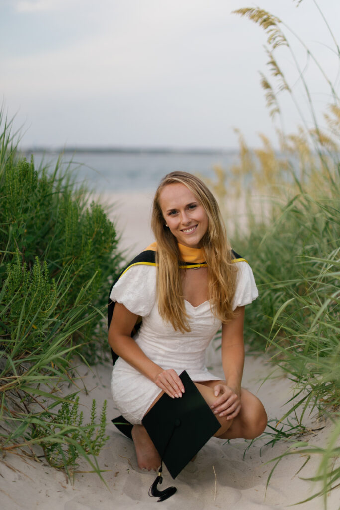 Coastal graduation portrait in the dunes and sea oats at Atlantic Beach NC