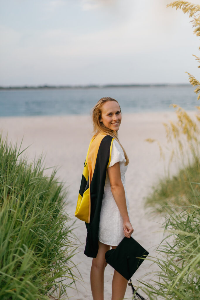 Senior graduation portrait among the dunes and sea oats at Atlantic Beach NC